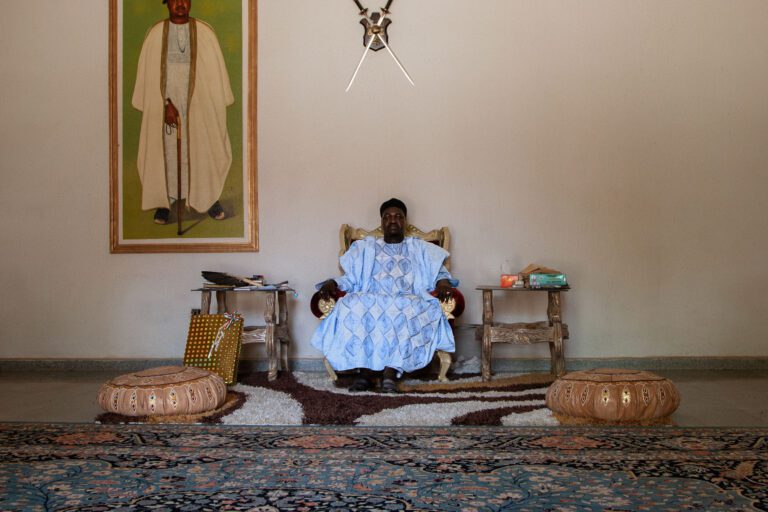 Portrait of Alh. Abubakar Umar Suleiman, 11th Emir of Bade (Mai Bade), Yobe State, seated in his traditional royal seats in the formal reception room, Gashua.