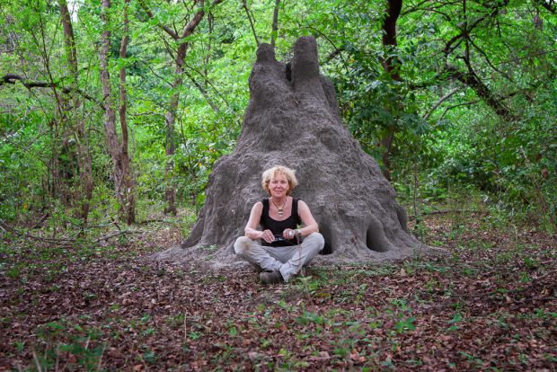 Amid the wild landscapes of Yankari National Park, Irene Becker sits beside an impressive termite house, exploring the natural wonders of Bauchi State.